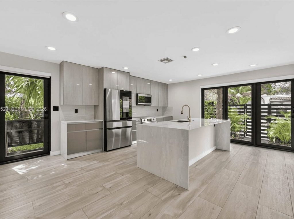 Open-plan kitchen with waterfall stone island